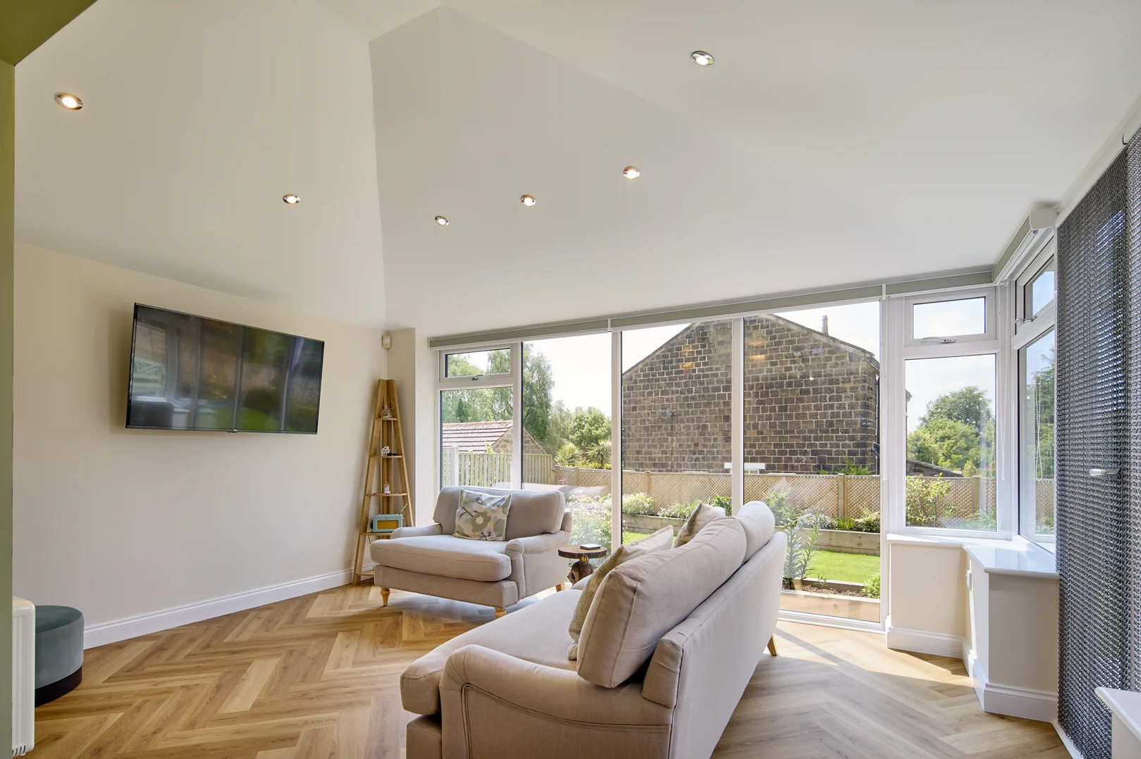 Interior photo of a solid roof extension with internal LE Ds and full height frames
